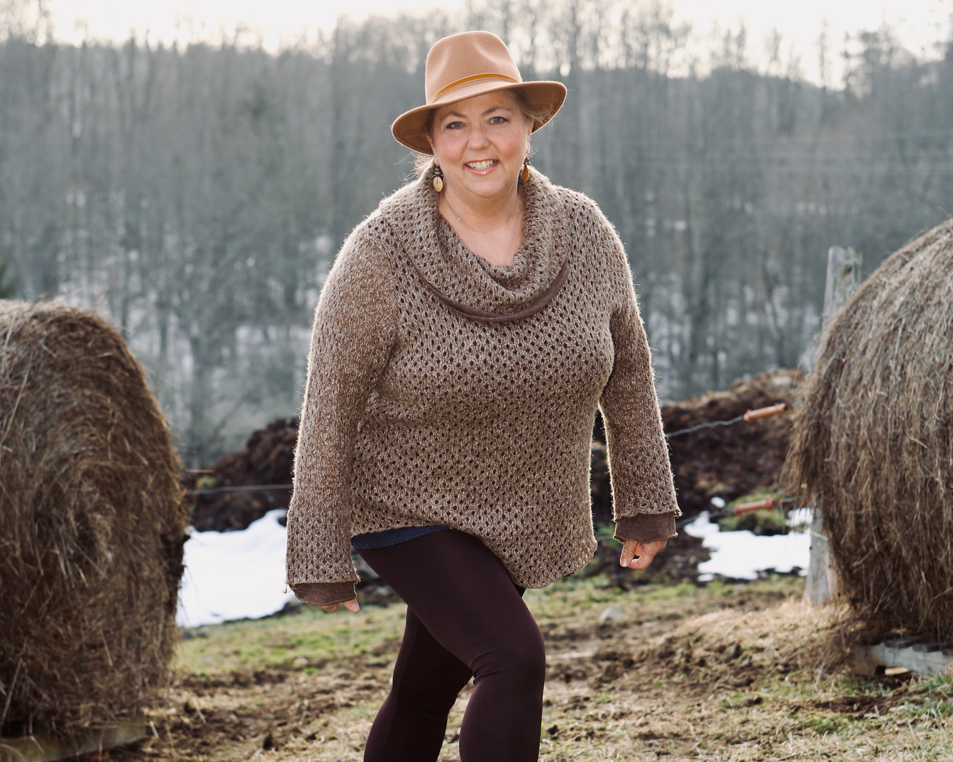 Laura Riposo-Hackney, certified healing practitioner and psychic medium, in a warm winter portrait showcasing her compassionate presence