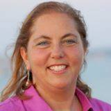 Laura Riposo-Hackney, certified healing practitioner and psychic medium, smiling warmly in professional portrait