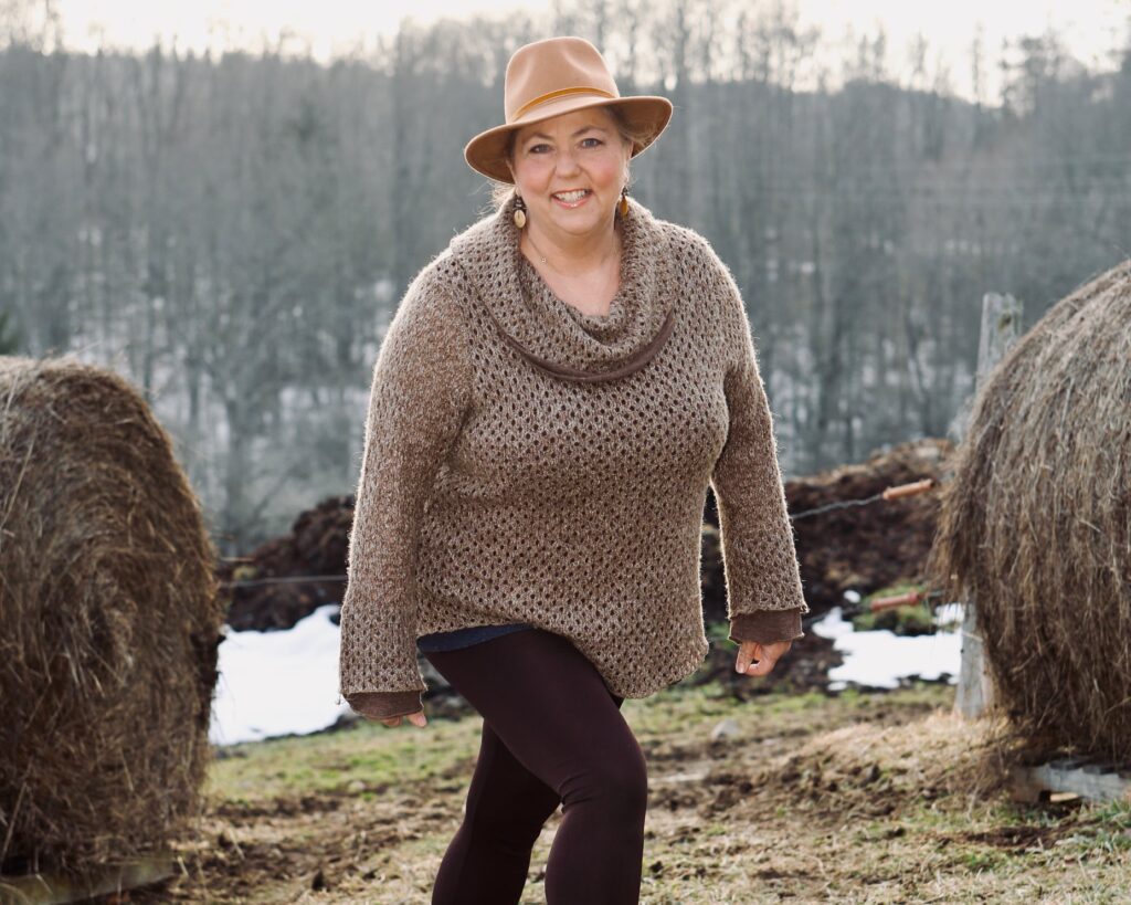 Laura Riposo-Hackney walking in a field during the winter.